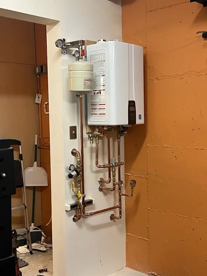 Plumbing technician inspecting water heater connections in Charleston